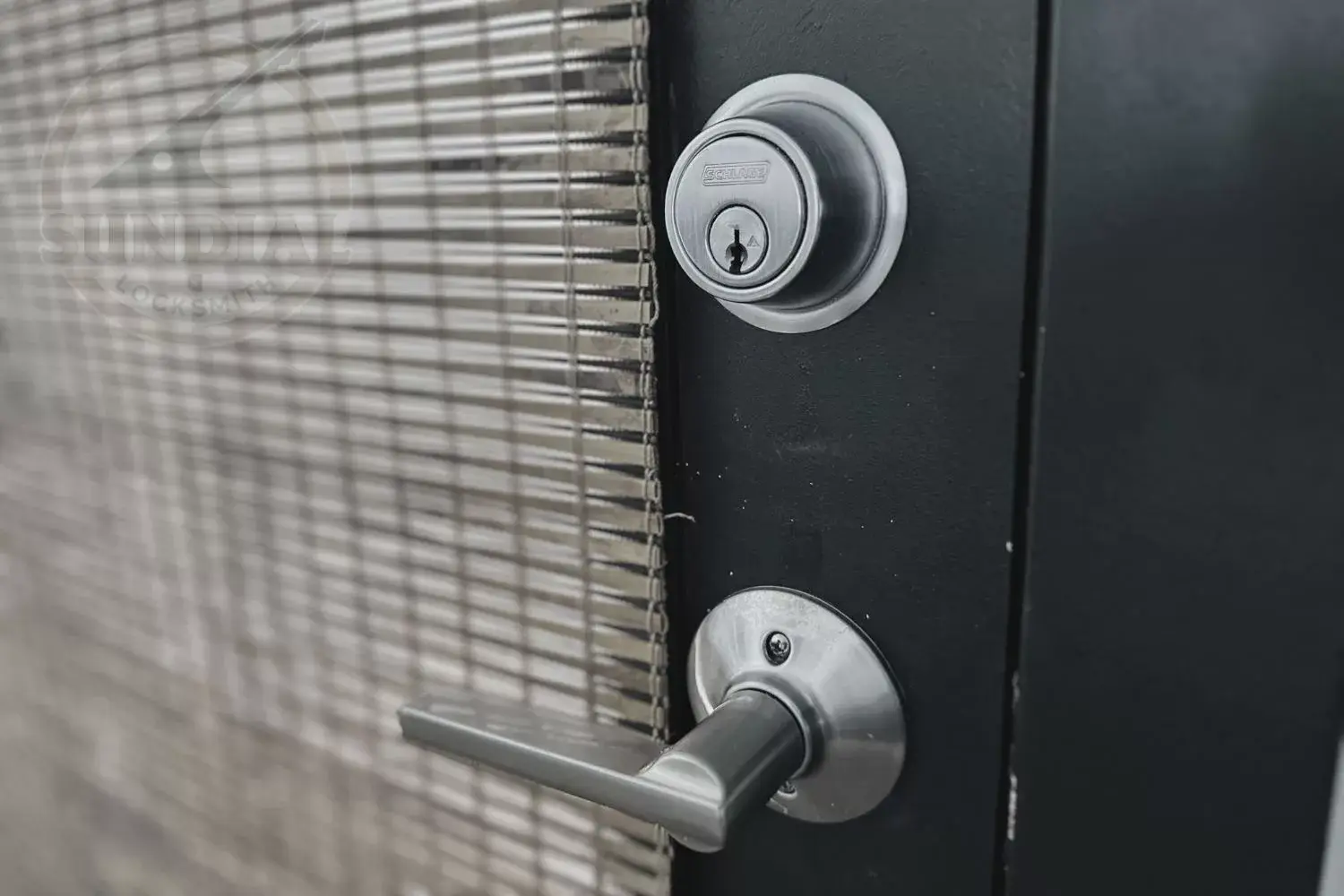 Locksmith changing a door lock.