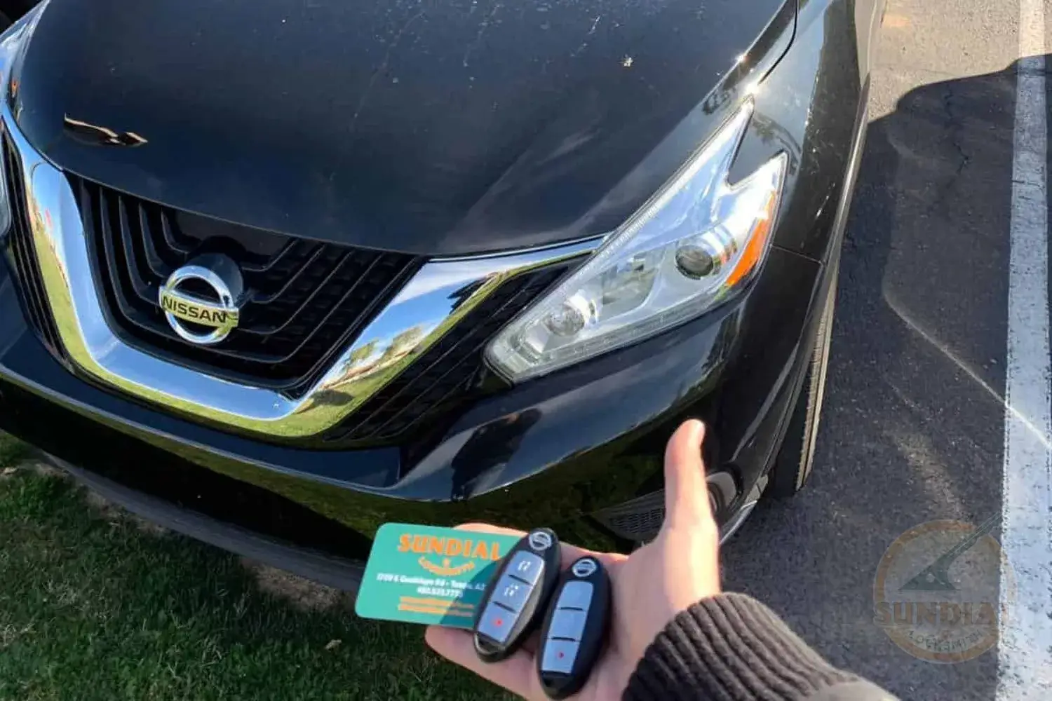 Key fob presentation in front of a Nissan Sedan