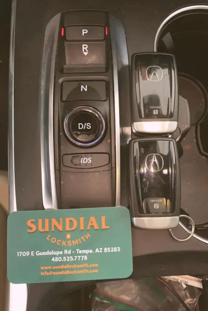 Car gear selector, memory seat buttons, locksmith business card.