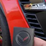 Red Corvette Z06 with key fob in foreground.