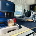 Automatic key cutting machine in workshop setting.