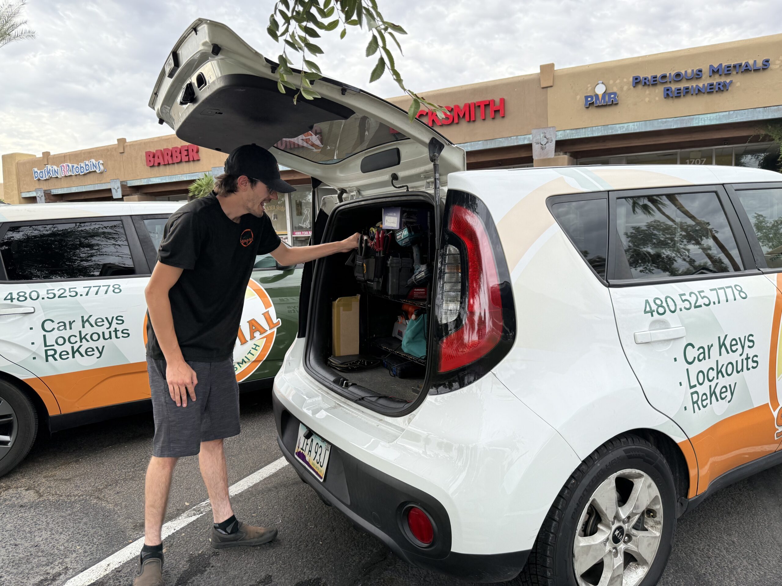 Sundial Locksmith technician working from a fully equipped mobile locksmith van in a parking lot, preparing tools for a car key or lockout service.