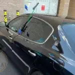 Locksmith aiding a car owner with a lockout