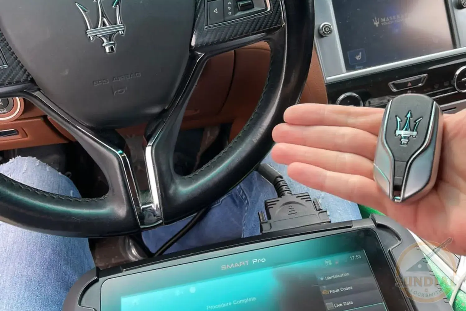 Luxury car interior with key fob and diagnostic tool.