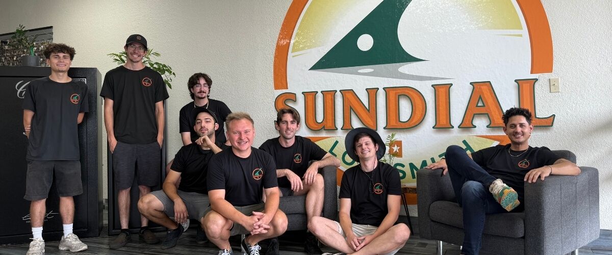 Sundial team in front of Sundial sign.