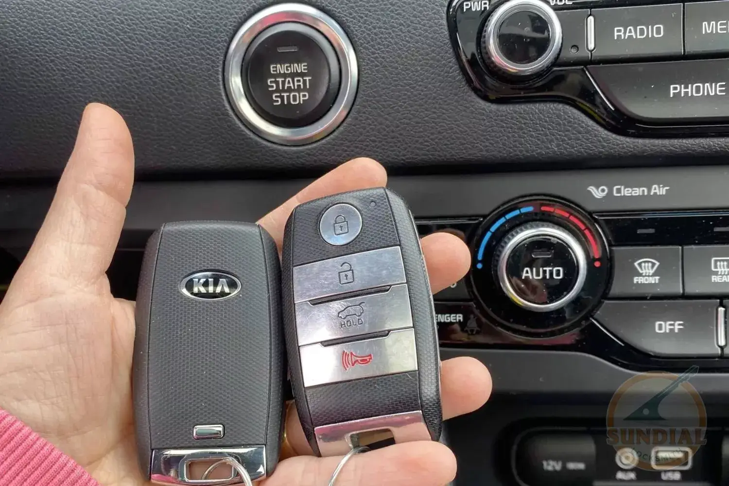 Car key fobs and dashboard with start button.